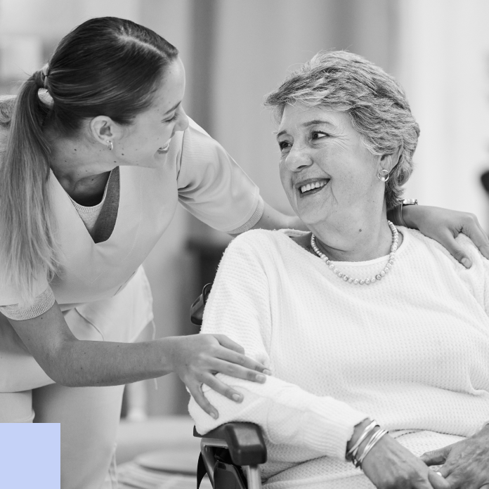 carer smiling to elderly lady